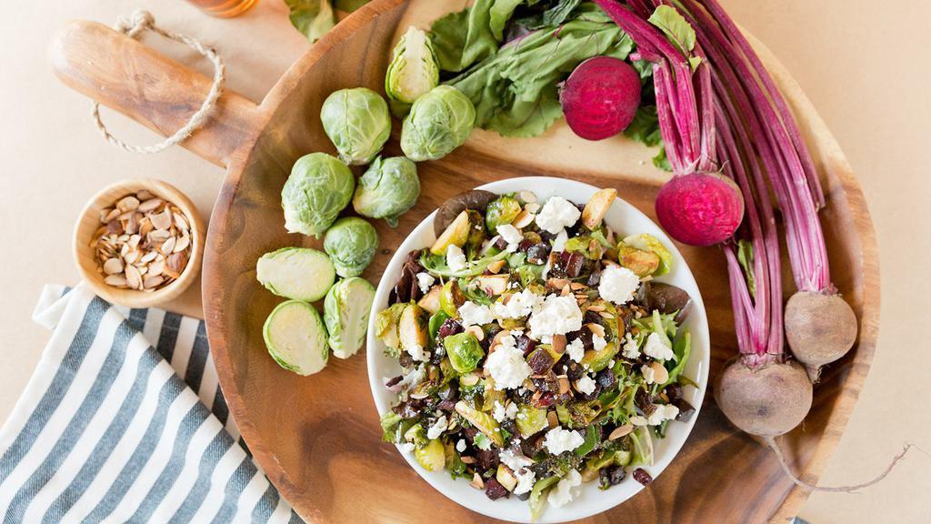 Roasted Brussels Sprouts Beet Salad · Spring lettuce mix, roasted Brussels sprouts, beets, golden raisins, red onions, sliced almonds, goat cheese and champagne vinaigrette.