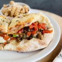 Steak Panino · Thinly sliced ribeye steak, mushrooms, mixed peppers, onions, mozzarella cheese, topped with...