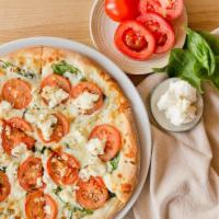 Bianca Pizza · Mozzarella, tomatoes, spinach, ricotta, Parmesan and rosemary and garlic.