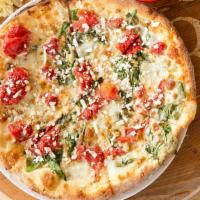 White Pizza · Fresh spinach, pomodoro tomatoes, mozzarella, garlic, Alfredo sauce and topped with feta.