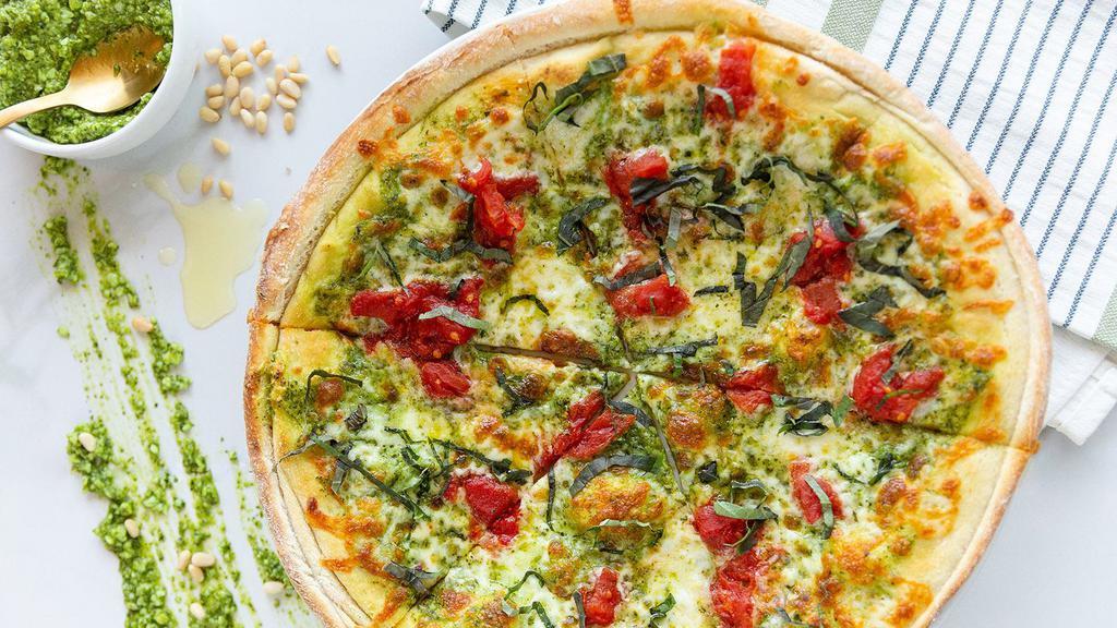 Pesto Pomodoro Pizza · Pesto, fresh mozzarella, pomodoro tomatoes and topped with fresh basil.