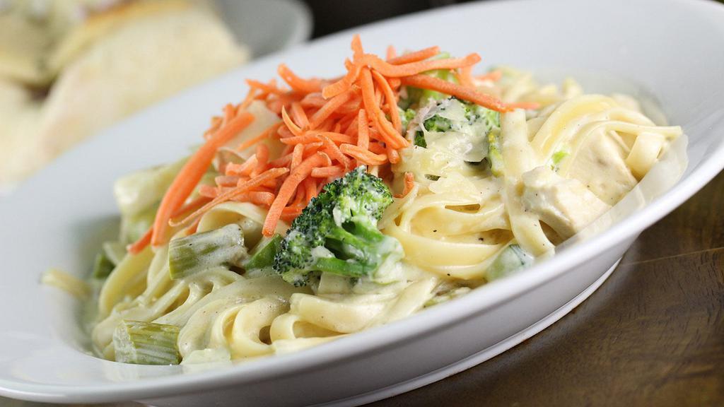 Chicken Fettuccine · Roasted chicken, broccoli, asparagus, yellow squash, zucchini, in a Parmesan garlic cream sauce, topped with carrots. Served on fettuccine.