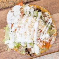 Tostadas · Crispy corn tortilla with refried beans, lettuce, tomatoes, avocado, sour cream, cheese, and...