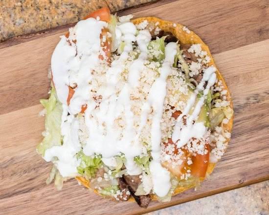 Tostadas · Crispy corn tortilla with refried beans, lettuce, tomatoes, avocado, sour cream, cheese, and your choice of meat.