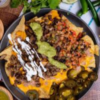 Super Nachos · Black Beans, cheese, guacamole, sour cream, salsa, and your choice of meat.
