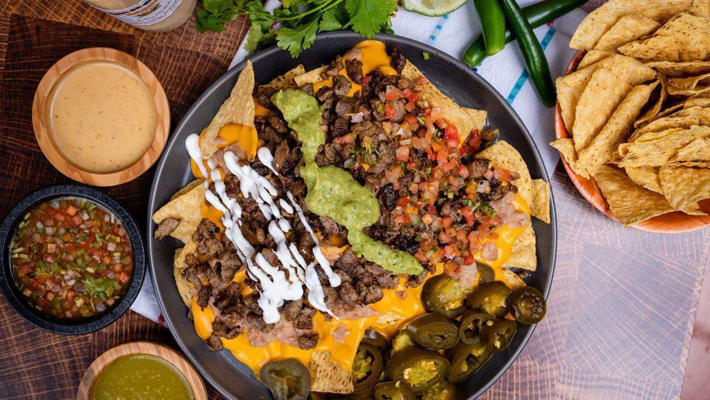 Super Nachos · Black Beans, cheese, guacamole, sour cream, salsa, and your choice of meat.