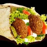 Falafel Wrap · Spread with hummus, pickles and topped with Jerusalem salad. Vegan.