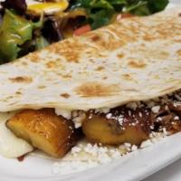 LARGE CUBAN QUESADILLA · Quesadilla made with shredded steak, sweet plantains, chihuahua and goat cheese. Served with...