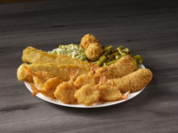 Supreme Sampler · Two pieces of our famous batter dipped fish, two chicken tenders, and six butterfly shrimp. Served with your choice of two sides and hush puppies.