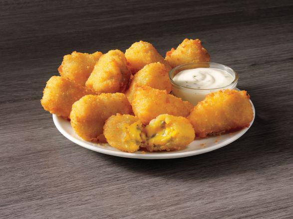 Jalapeño Poppers · Golden fried jalapeños and cheese that’s just begging to be dipped in ranch, will start your meal with a kick.