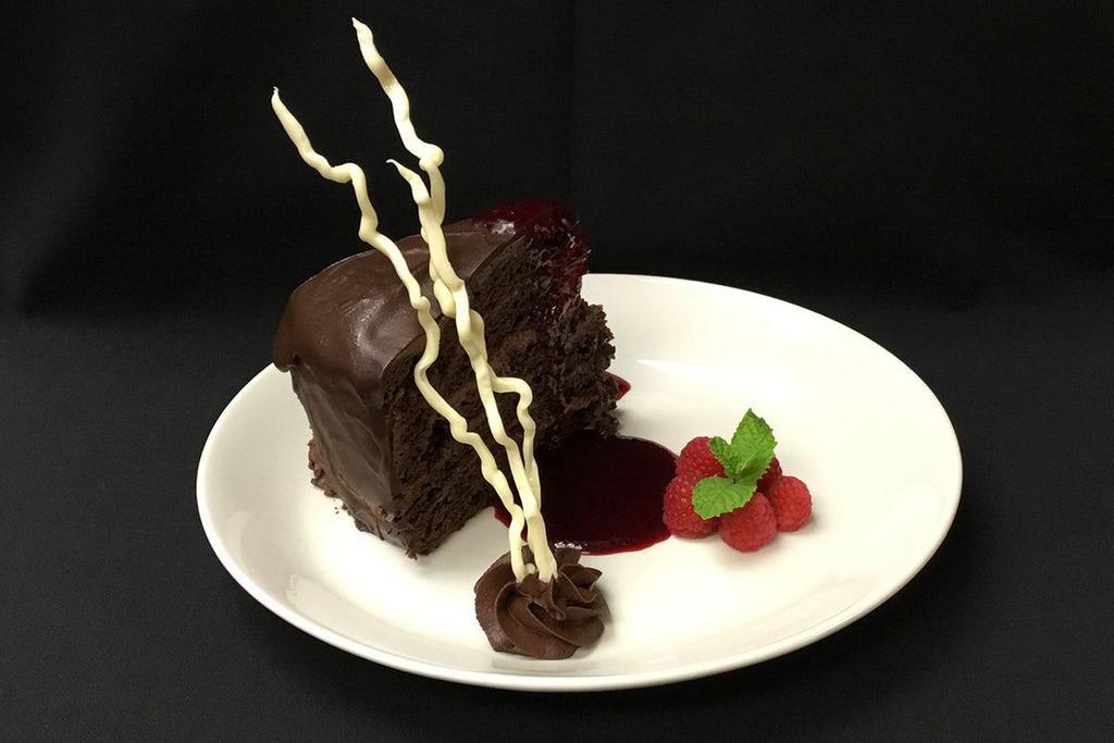 MOONLIGHT CHOCOLATE CAKE · Layers of Rich Chocolate Cake, Indulgent Mousse, Raspberry Preserves, Encased in a Chocolate Ganache Icing 