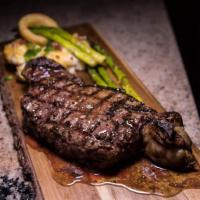 NY Strip Steak Dinner · 12oz NY Strip Steak served with onion rings and French Fries with a side of steak sauce and ...