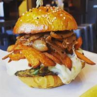 Quinoa Casino Burger · Homemade crispy quinoa burger topped with sweet potato fries, beer caramelized onions and gr...