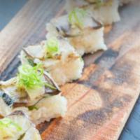 Saba Oshizushi · Seared mackerel, sesame seed, ponzu sauce, soy sauce and mint leaf. 7 pieces.