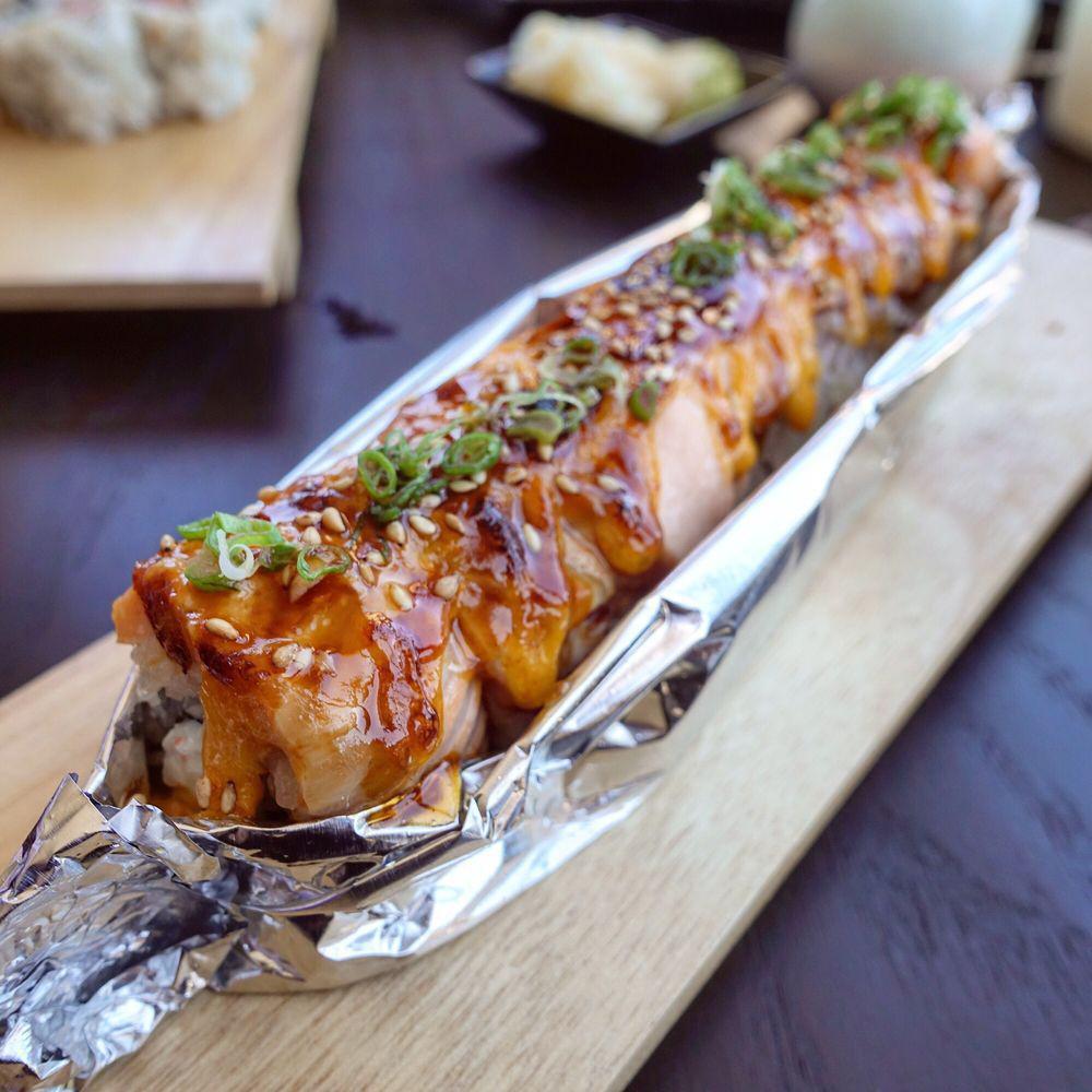 Lion King Roll (Baked) · Imitation Crab and avocado topped with bake salmon, spicy mayo sauce, eel sauce, sesame seeds, and green onion