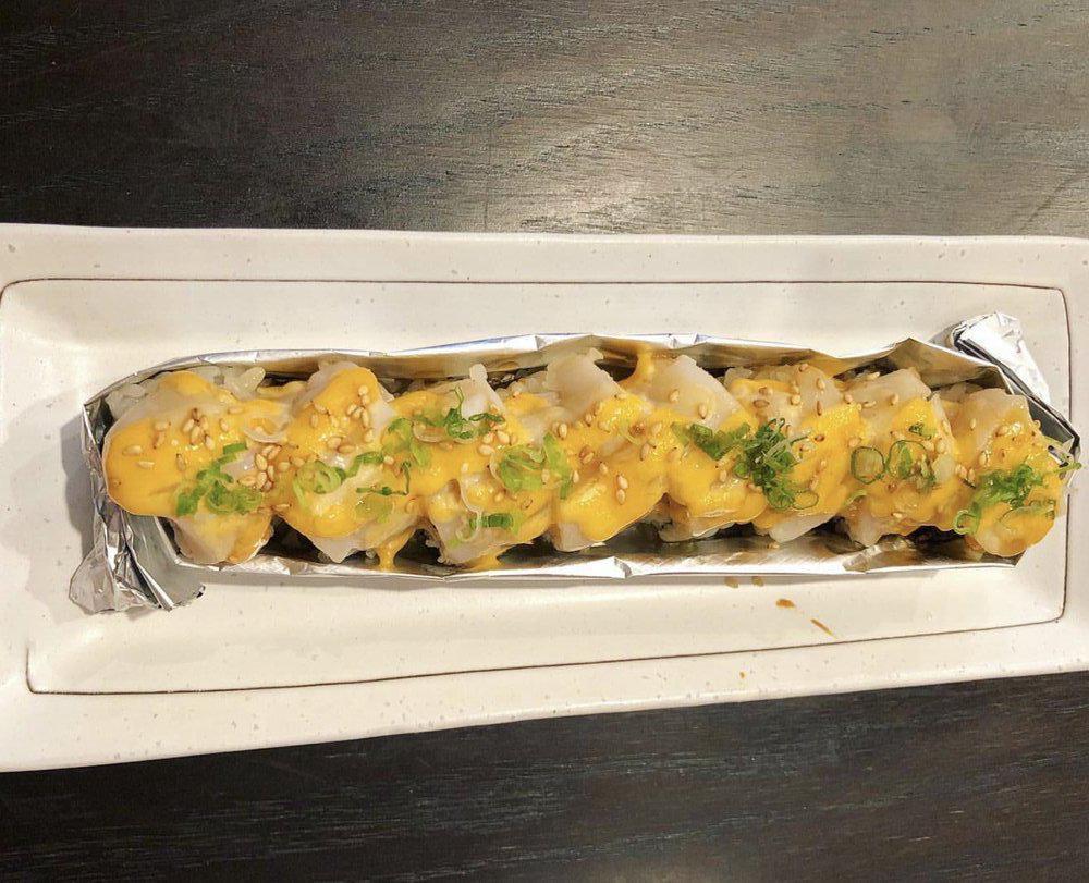 Scallop Lover Roll (Baked) · Imitation Crab and eel topped with baked scallop, spicy mayo sauce, eel sauce, sesame seed and green onion
