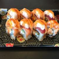 Ryoshin Roll · Eel, avocado topped with tuna, salmon, Imitation crab, house sauce, sesame seed and green on...