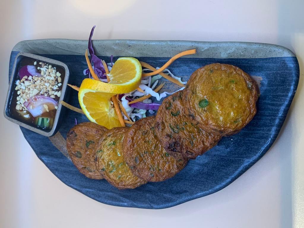 Thai Fish Cake · Tod mun pla. Thai Red-curry-flavoured fish cakes (cod fish) mix with herbal sliced and deep fried served served with sweet and sour sauce.