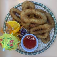 Fried Calamari ปลาหมึกทอด · Lightly battered calamari, breaded, golden-fried served with sweet & sour sauce
