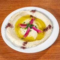 Hummus · Chickpeas pureed with tahini sauce, fresh lemon juice and a hint of olive oil. Served with w...