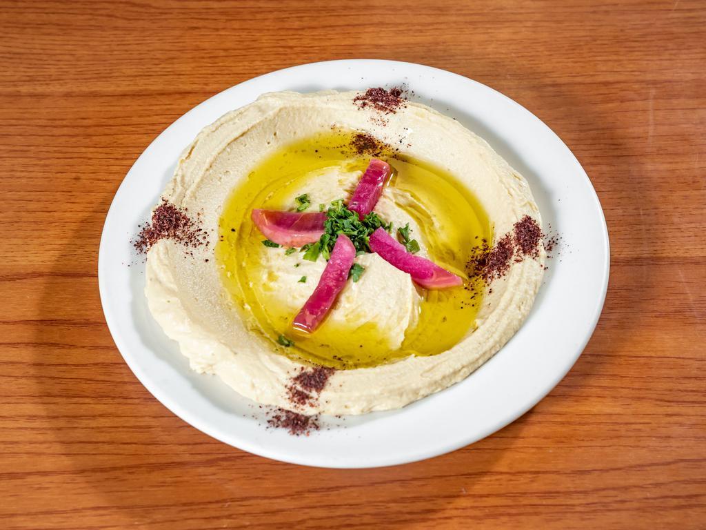 Hummus · Chickpeas pureed with tahini sauce, fresh lemon juice and a hint of olive oil. Served with warm pita bread.