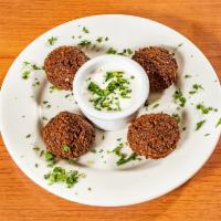 Falafel · Fresh ground chickpeas with herbs and spices, fried until golden brown and served with speci...