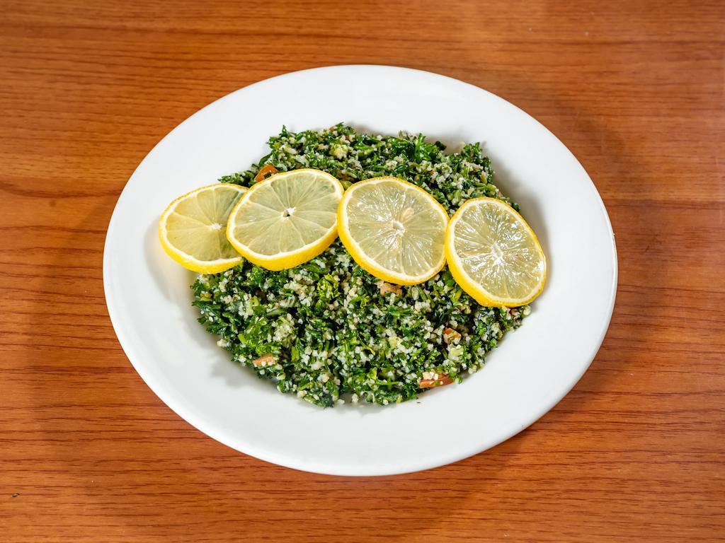 Tabouli Salad · Finely chopped parsley, diced cucumbers and tomatoes mixed with burghul. Seasoned with lemon juice with pure olive oil.