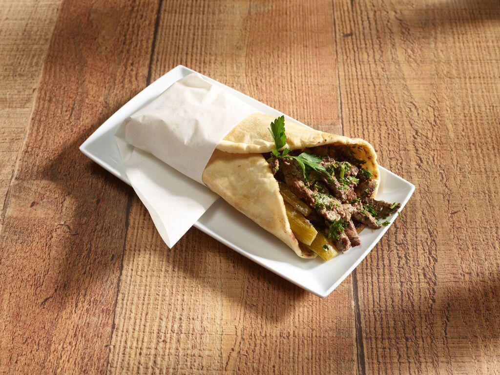 Beef and Lamb Shawarma Sandwich · Marinated thin slices of tender lamb and beef. Topped with tahini sauce, pickles, and parsley.