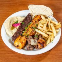 Mediterranean Grill Trio · Mashawi plate. 1 skewer of lamb shish kebab, 1 skewer of chicken tikka kebab, and 1 skewer o...