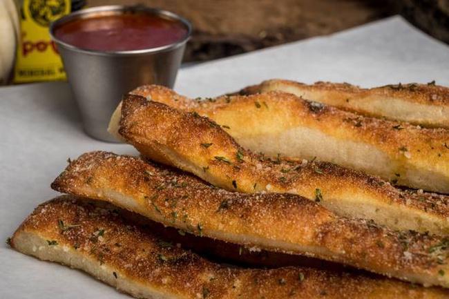 Breadsticks · Handcrafted using our fresh baked dough, sliced into approximately 10 pieces, topped with whole milk mozzarella, served with house marinara.