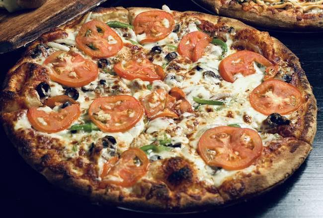 Veggie Specialty Pies · Roma tomatoes, mushrooms, onions, green peppers, black olives, fresh garlic, whole milk mozzarella, house pizza sauce.