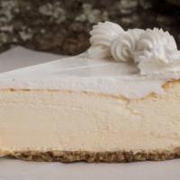 NY Style Cheesecake · Smooth and creamy classic New York-style cheesecake, topped with a hint of light whipped cre...
