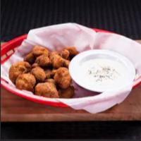 Breaded Mushrooms · Delicious hand breaded whole mushrooms deep fried. Served with a side of ranch.