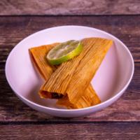Tamales · 2 pork or chicken tamales in red salsa.