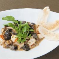 Sauteed Escargot and Prawns · Served with hamakua mushrooms, roasted chili garlic and a touch of cream.