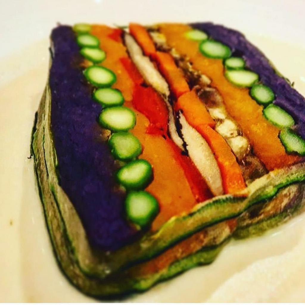 Vegetable Terrine with Green Curry Sauce · Layers of purple Okinawan potato, asparagus, shiitake mushroom, roasted bell pepper, roasted carrot and mashed kabocha pumpkin. Gluten free.