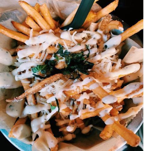 Truffle Fries · Thin cut fries topped with parmesan cheese & basil, drizzled with truffle aioli.