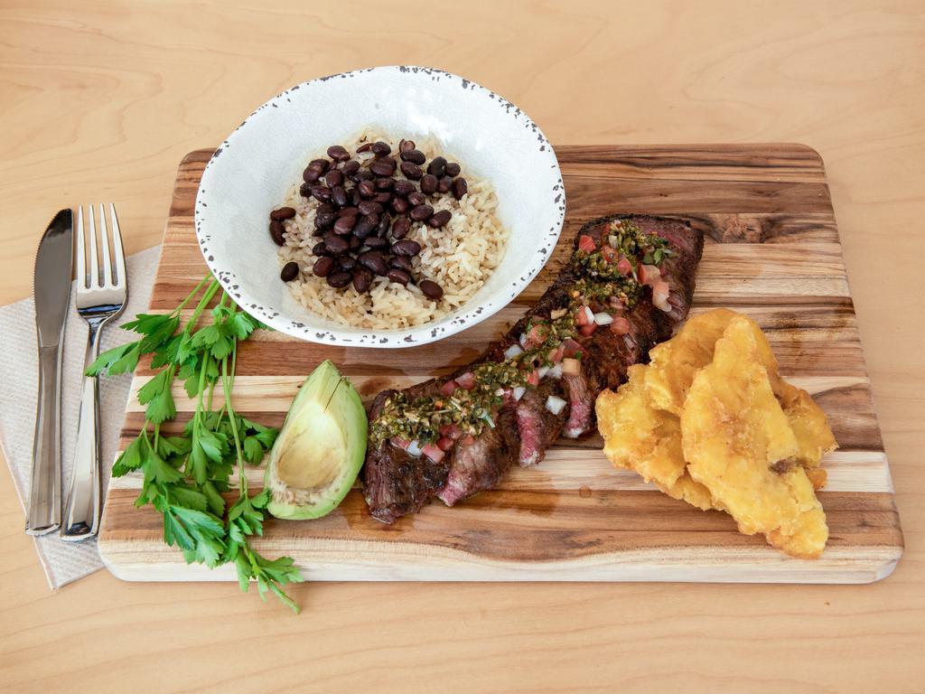 Churrasco Plate · 8 oz. skirt steak marinated in chimichurri. Served with rice, beans, avocado, pico de gallo and tostones.