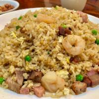 Young Chow Fried Rice · A mixture of ham, shrimp, pork, eggs, and peas.