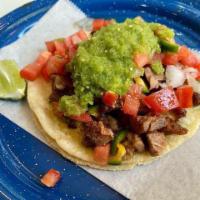 Carnitas Taco · Traditional michoacan style pork carnitas, pico de gallo, salsa verde on double tortilla.