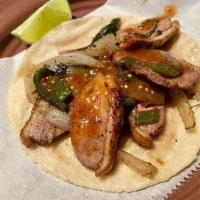 Pato Taco · Premium seared duck breast, caramelized onions, roasted poblano pepper, and salsa.