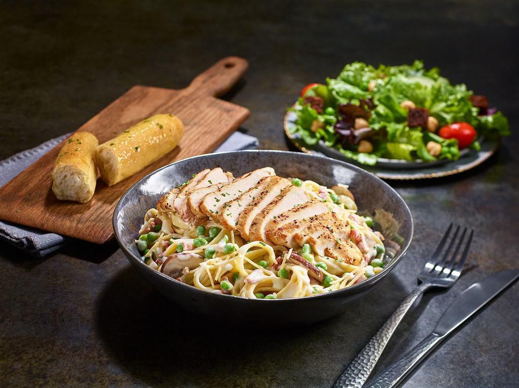 NEW Chicken Carbonara · Grilled chicken served atop fettuccine tossed with alfredo sauce, bacon, peas, roasted baby bellas, and Parmesan cheese.