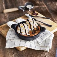 Chocolate Chip Skillet Cookie · A freshly baked chocolate chip cookie served warm in a