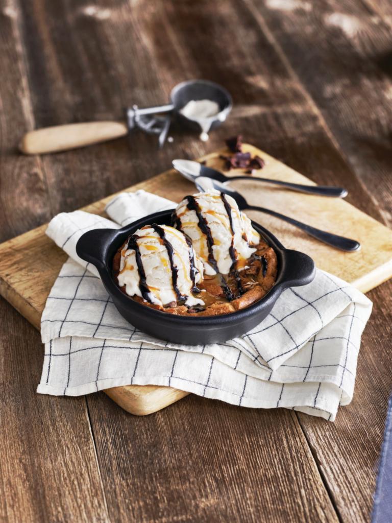 Chocolate Chip Skillet Cookie · A freshly baked chocolate chip cookie served warm in a