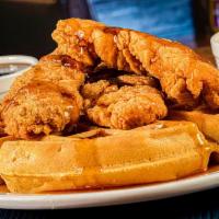 Chicken and Waffles · Our Belgian Waffle topped with crunchy chicken tenders. Served with breakfast syrup and Buff...