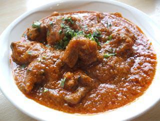 Lamb Madras · Lamb cooked in tangy coconut stew flavored with ginger and curry leaves, comes with rice