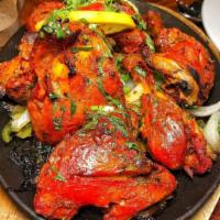 Tandoori chicken · Marinated half spring chicken roasted in tandoor.