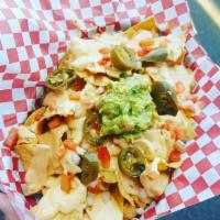 Happy Hour Nachos · House made chips smothered is creamy queso, pickled jalapenos , pico de gallo