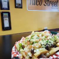 Carne Asada Fries · Fries and carne asada. Smothered in cream queso, shredded cheese, Pico de gallo, sour cream ...