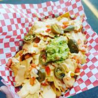 Nachos · House made chips smothered is creamy queso, pickled jalapenos , pico de gallo and topped wit...
